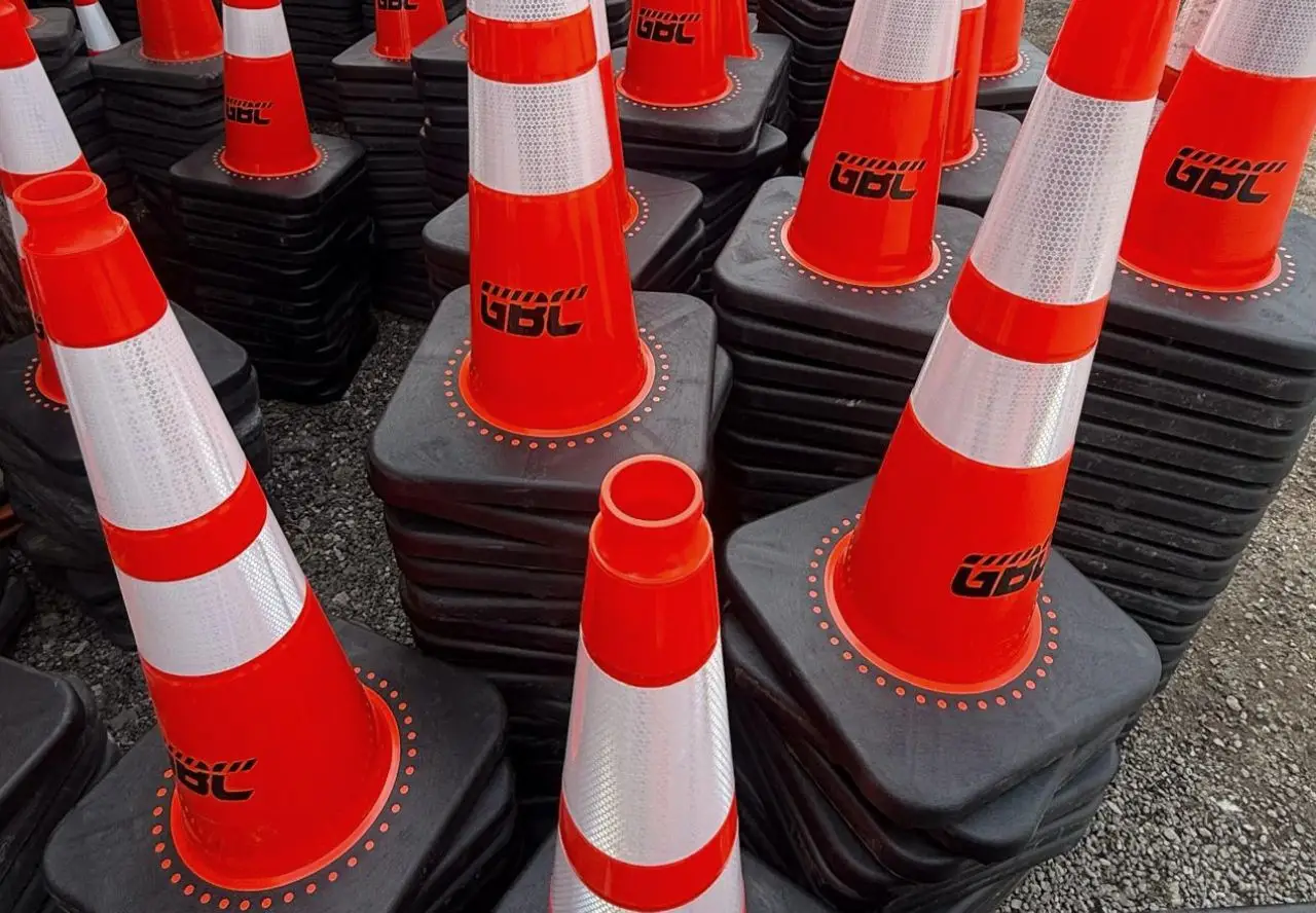 GBC-branded reflective cones and barricade bases staged at the yard